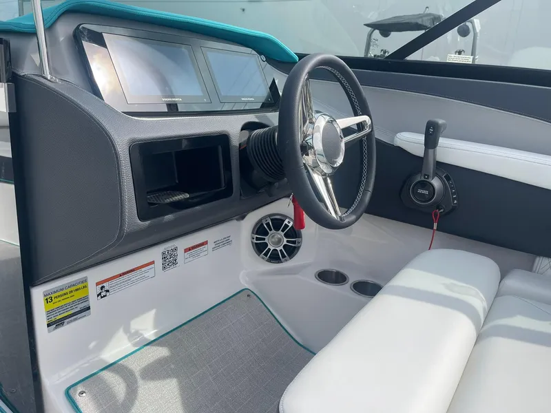 Slide: The Image of 2024 Regal LS4 boat cockpit with steering wheel and control panel. - 8