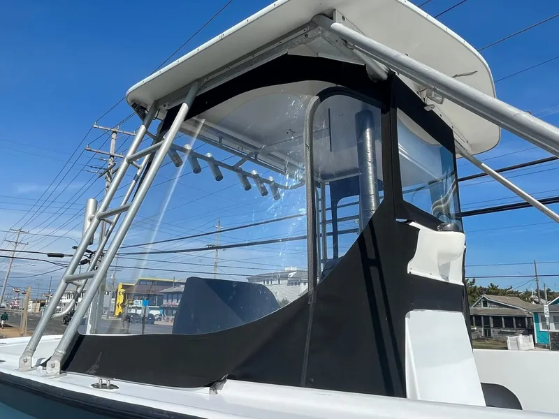 Slide: The Image of 1968 Wahoo Alglas 25 boat with a black canopy and clear windows. - 12