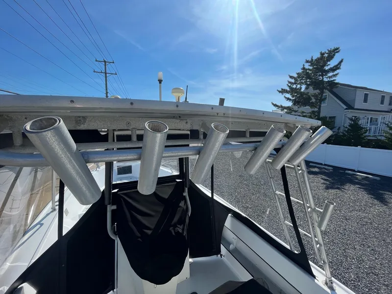 Slide: The Image of 1968 Wahoo Alglas 25 boat with rod holders under a clear blue sky. - 15