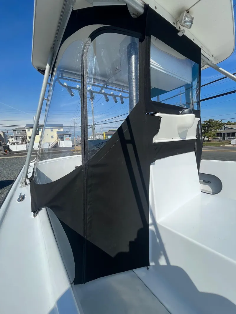 Slide: The Image of 1968 Wahoo Alglas 25 boat with black canvas enclosure and white interior. - 17