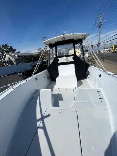 Slide: The Image of 1968 Wahoo Alglas 25 boat with open deck and canopy. - 22