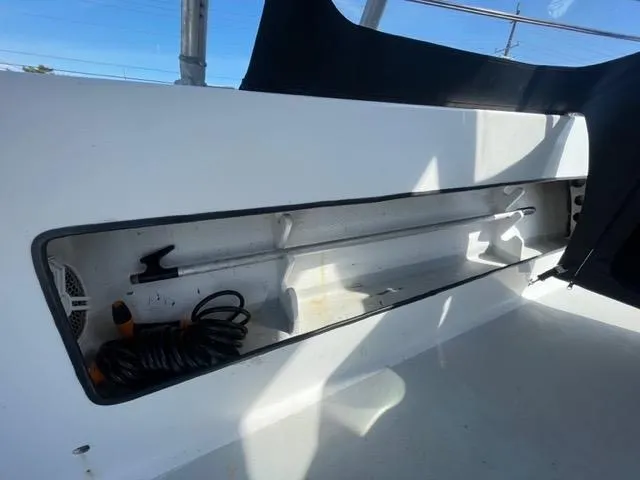 Slide: The Image of Storage compartment on a 1968 Wahoo Alglas 25 boat with coiled rope and tools. - 26