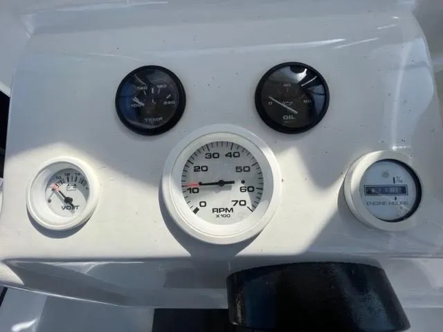 Slide: The Image of Dashboard of a 1968 Wahoo Alglas 25 boat with gauges for RPM, temperature, oil, volts, and engine hours. - 34