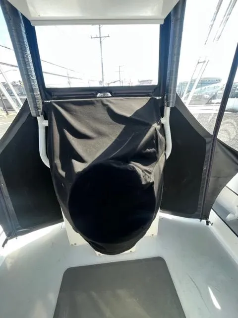 Slide: The Image of 1968 Wahoo Alglas 25 boat interior with covered helm station. - 37