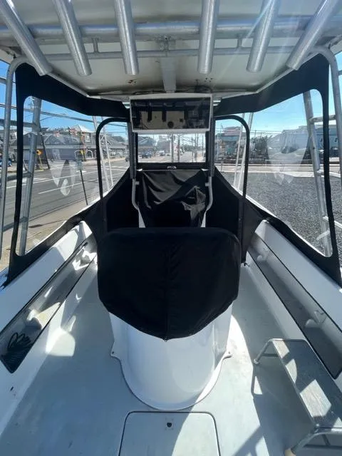 Slide: The Image of 1968 Wahoo Alglas 25 boat interior with covered console and seating. - 40