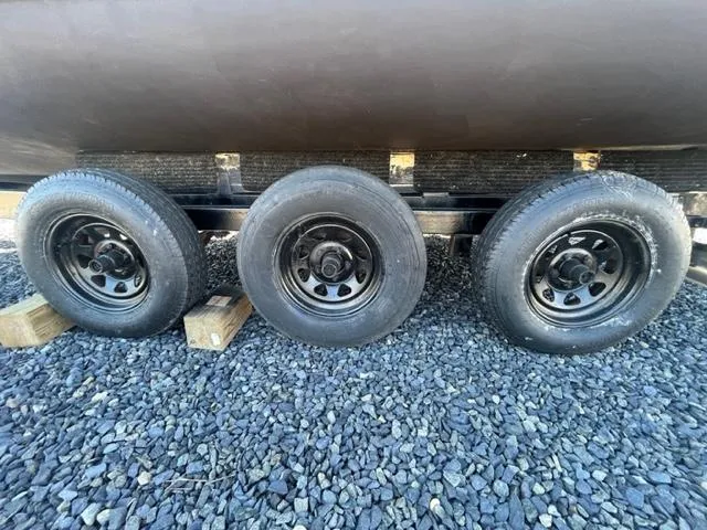 Slide: The Image of Trailer wheels of a 1968 Wahoo Alglas 25 boat on gravel. - 44