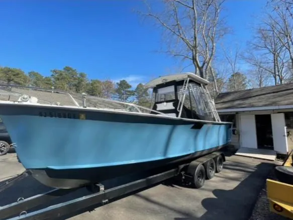 Slide: The Image of 1968 Wahoo Alglas 25 boat on a trailer in a driveway. - 7