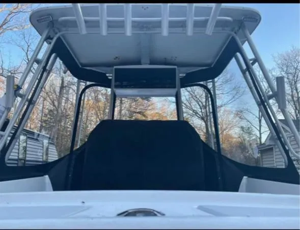 Slide: The Image of 1968 Wahoo Alglas 25 boat cockpit with T-top and black canvas cover. - 9