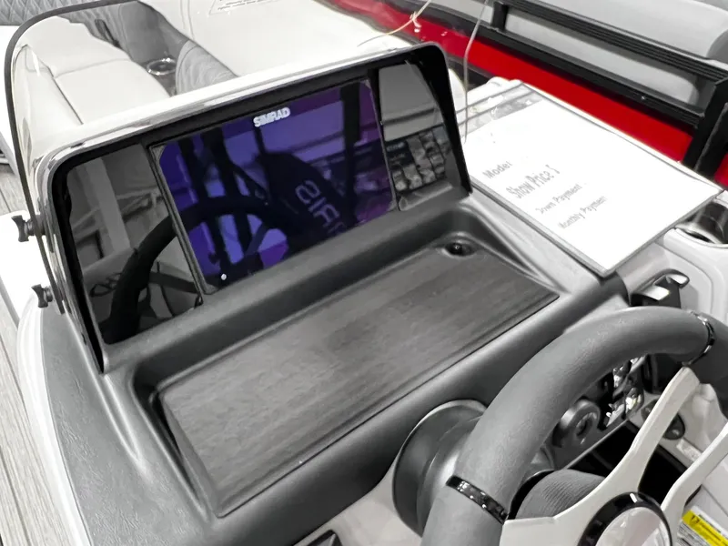 Slide: The Image of 2024 Harris Sunliner 250 Sport boat dashboard with Simrad display. - 13