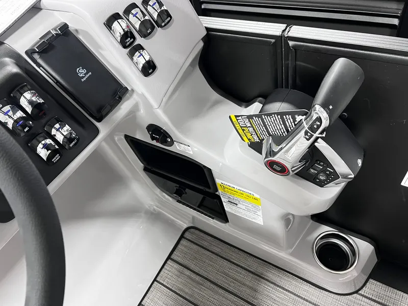 Slide: The Image of 2024 Harris Sunliner 250 Sport boat control panel and throttle. - 15