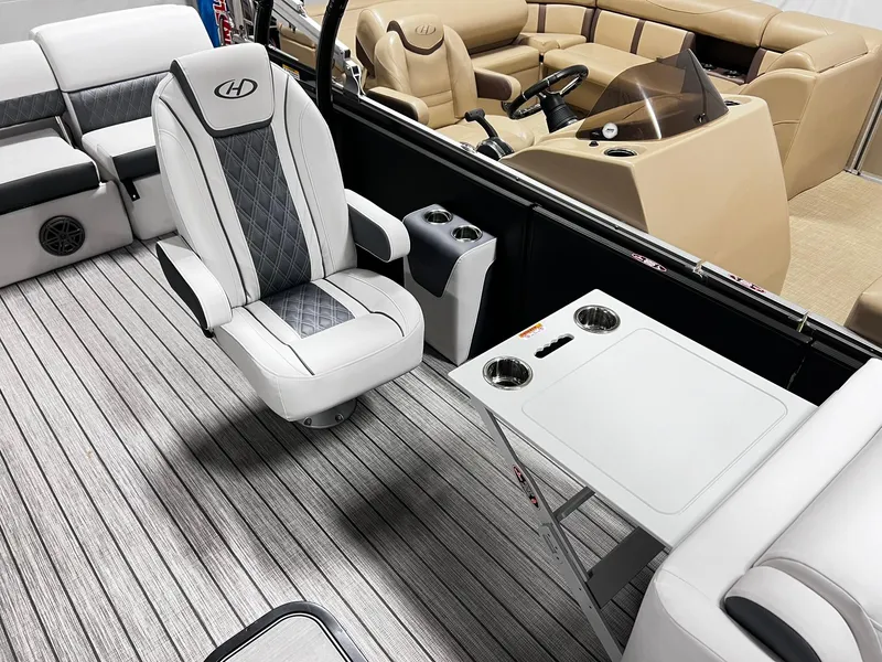 Slide: The Image of 2024 Harris Sunliner 250 Sport boat interior with captain's chair and table. - 20