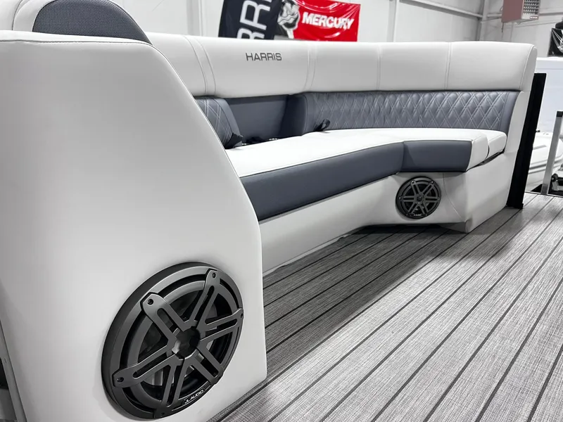 Slide: The Image of 2024 Harris Sunliner 250 Sport boat interior with premium seating and built-in speakers. - 21