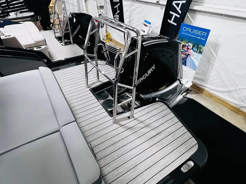 Slide: The Image of 2024 Harris Sunliner 250 Sport boat with Mercury engines and sleek deck design. - 23