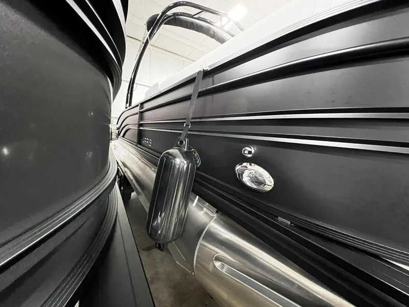 Slide: The Image of 2024 Harris Sunliner 250 Sport pontoon boat in a showroom. - 24