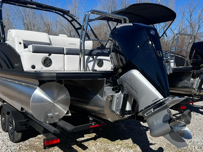 Slide: The Image of 2024 Harris Sunliner 250 Sport pontoon boat with powerful outboard motor. - 26
