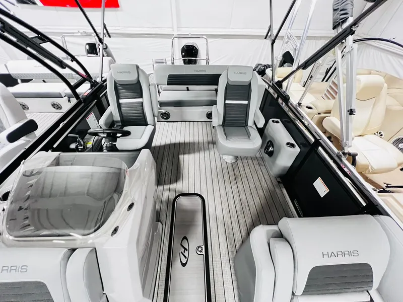 Slide: The Image of 2024 Harris Sunliner 250 Sport boat interior with gray seating and modern design. - 9