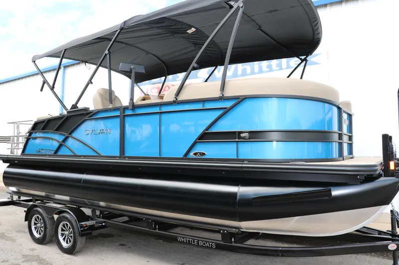 Slide: The Image of 2025 Sylvan Mirage X3 CLZ DH pontoon boat with blue exterior and black canopy. - 11