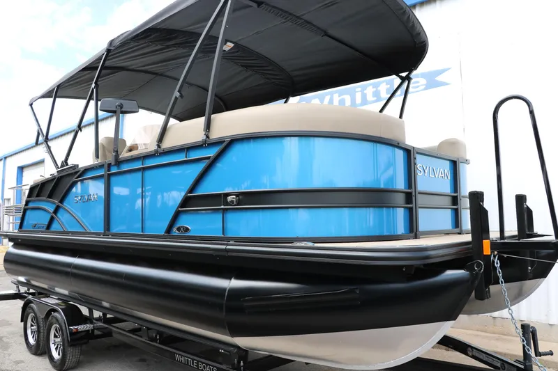 Slide: The Image of 2025 Sylvan Mirage X3 CLZ DH pontoon boat with blue exterior and black canopy. - 12
