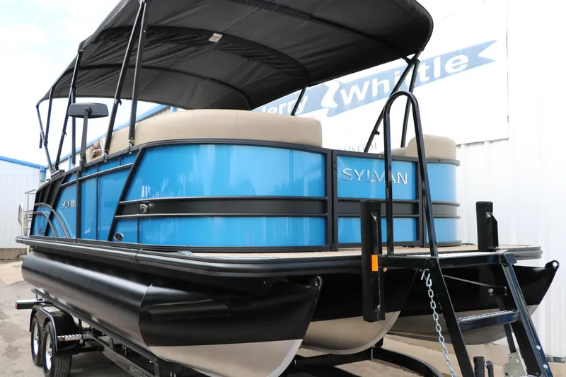 Slide: The Image of 2025 Sylvan Mirage X3 CLZ DH pontoon boat with blue exterior and black canopy. - 13