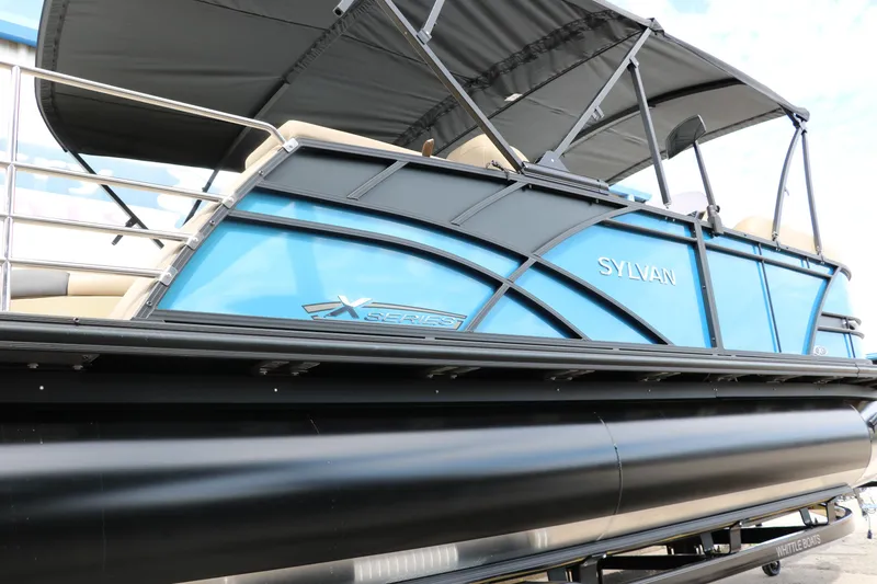 Slide: The Image of 2025 Sylvan Mirage X3 CLZ DH pontoon boat with blue exterior and canopy. - 16