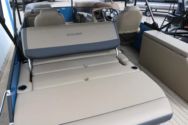 Slide: The Image of 2025 Sylvan Mirage X3 CLZ DH pontoon boat interior with beige seating and modern dashboard. - 20