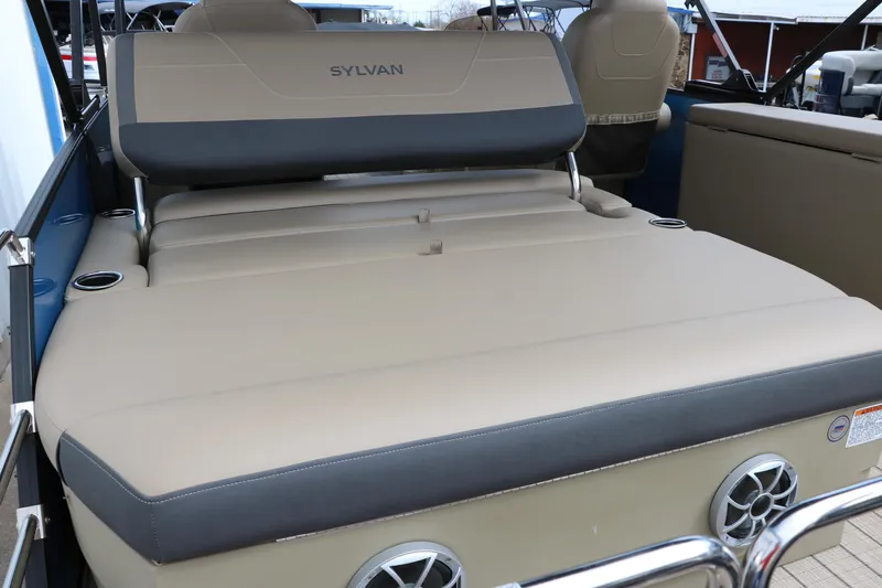 Slide: The Image of 2025 Sylvan Mirage X3 CLZ DH boat interior with beige seating and cup holders. - 21