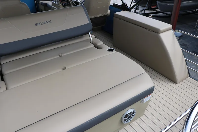 Slide: The Image of 2025 Sylvan Mirage X3 CLZ DH boat interior with beige seating and flooring. - 23