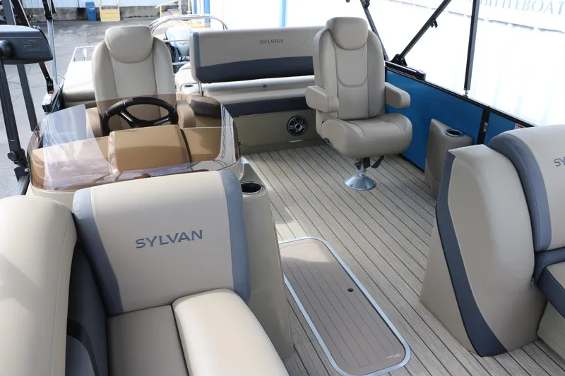 Slide: The Image of 2025 Sylvan Mirage X3 CLZ DH boat interior with beige seating and steering wheel. - 26