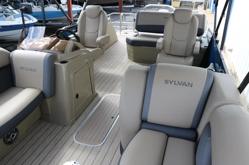 Slide: The Image of 2025 Sylvan Mirage X3 CLZ DH pontoon boat interior with luxurious seating and helm. - 27