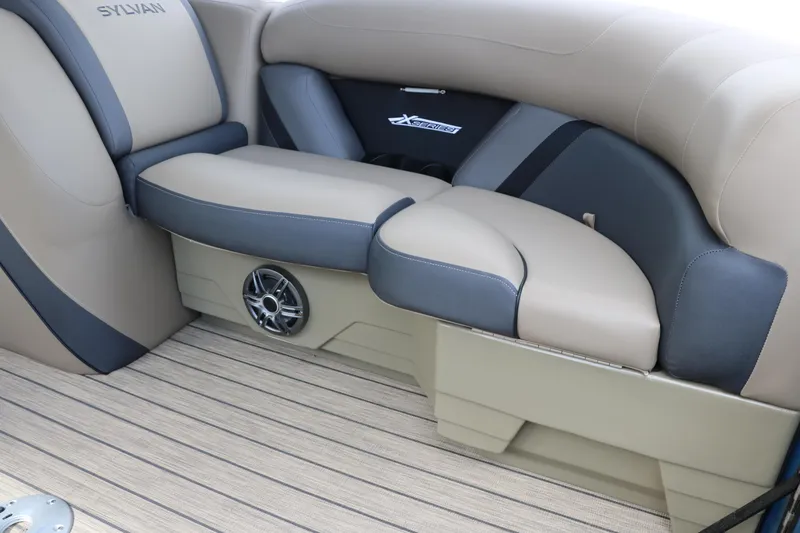 Slide: The Image of 2025 Sylvan Mirage X3 CLZ DH boat interior with beige and gray seating. - 28