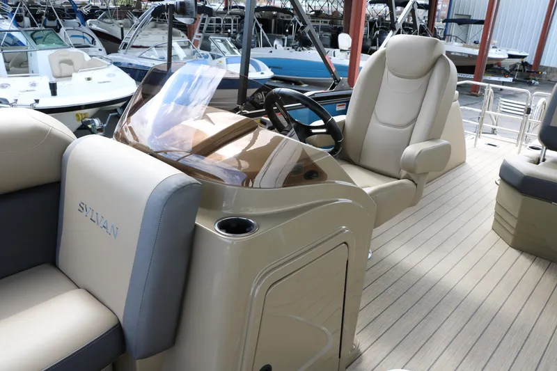 Slide: The Image of 2025 Sylvan Mirage X3 CLZ DH boat interior with helm and seating area. - 30