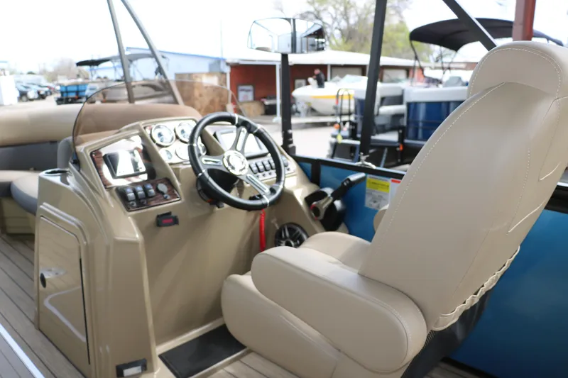 Slide: The Image of 2025 Sylvan Mirage X3 CLZ DH boat interior with steering wheel and control panel. - 32