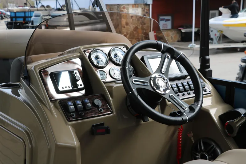Slide: The Image of 2025 Sylvan Mirage X3 CLZ DH boat dashboard with steering wheel and control panel. - 35