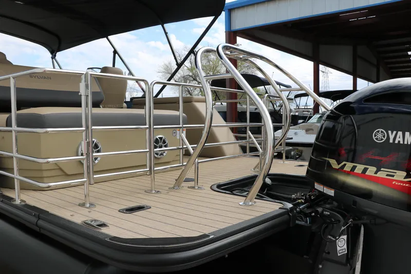 Slide: The Image of 2025 Sylvan Mirage X3 CLZ DH pontoon boat with Yamaha engine, docked under shelter. - 6