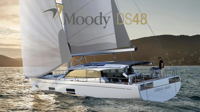 The Image of Sailing yacht Moody 48 deck saloon 2026 navigating through blue waters near a forested coastline. - 0