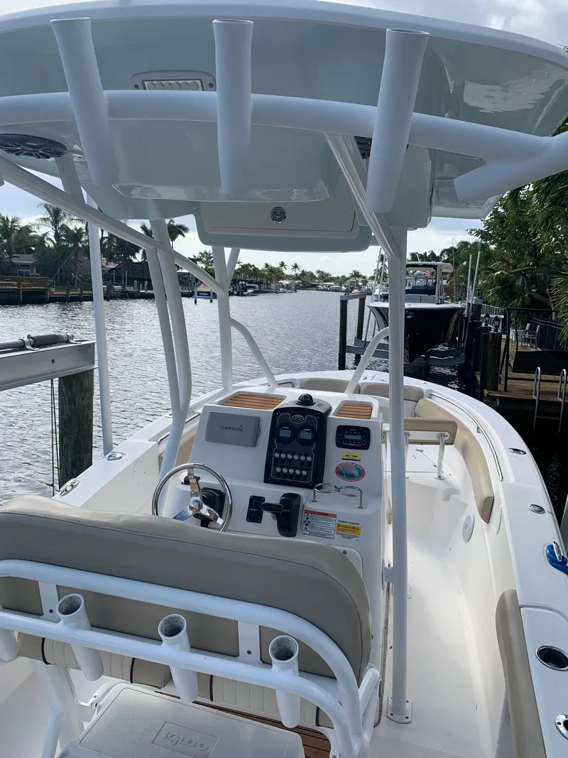 Slide: The Image of 2017 Sea Fox 226 Commander boat with center console and T-top on a calm waterway. - 12