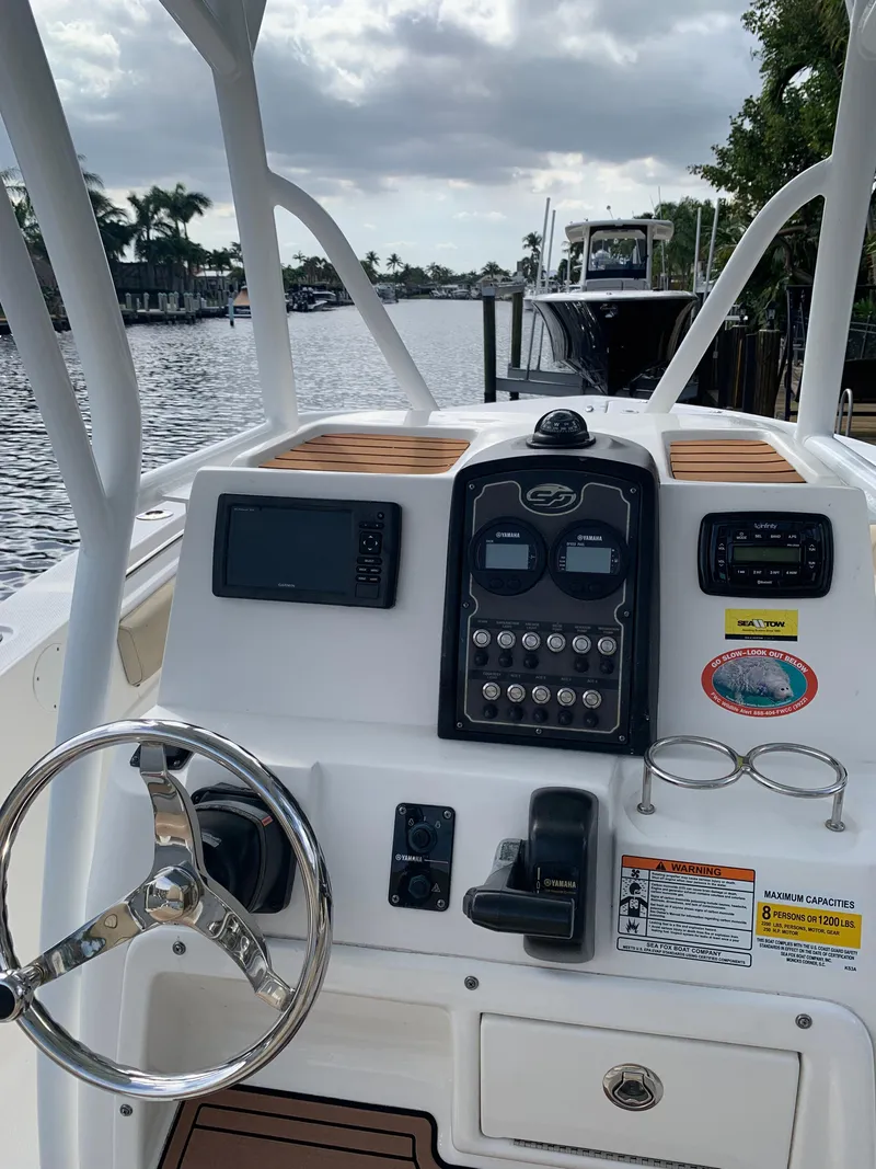 Slide: The Image of 2017 Sea Fox 226 Commander boat console with steering wheel and navigation controls. - 9