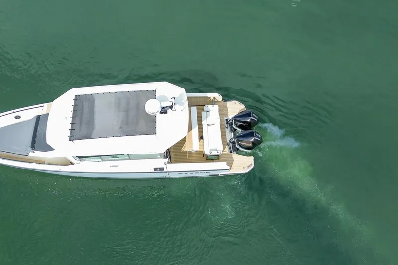 Slide: The Image of Aerial view of 2026 Saxdor 320 GTC boat cruising on green water. - 30