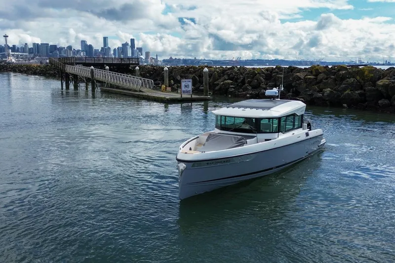 Slide: The Image of Saxdor 320 GTC 2026 cruising near a dock with city skyline in background. - 34