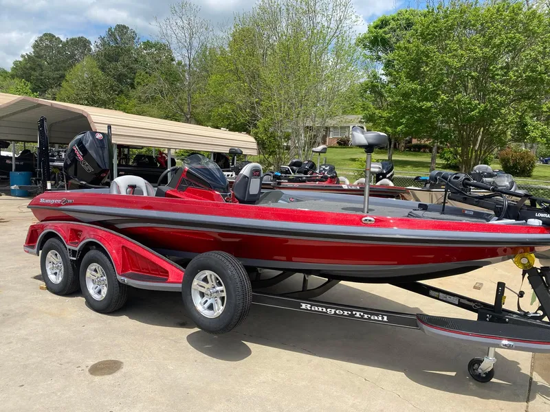 Slide: The Image of 2024 Ranger Z519 Ranger Cup Equipped boat in red, parked on a trailer. - 9