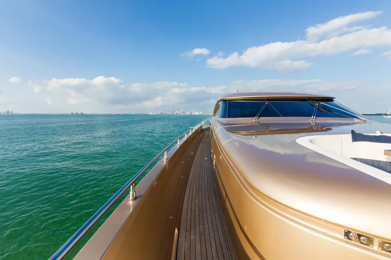 Slide: The Image of Luxurious AB 118 yacht cruising on open water, 2010 model, with city skyline in background. - 45