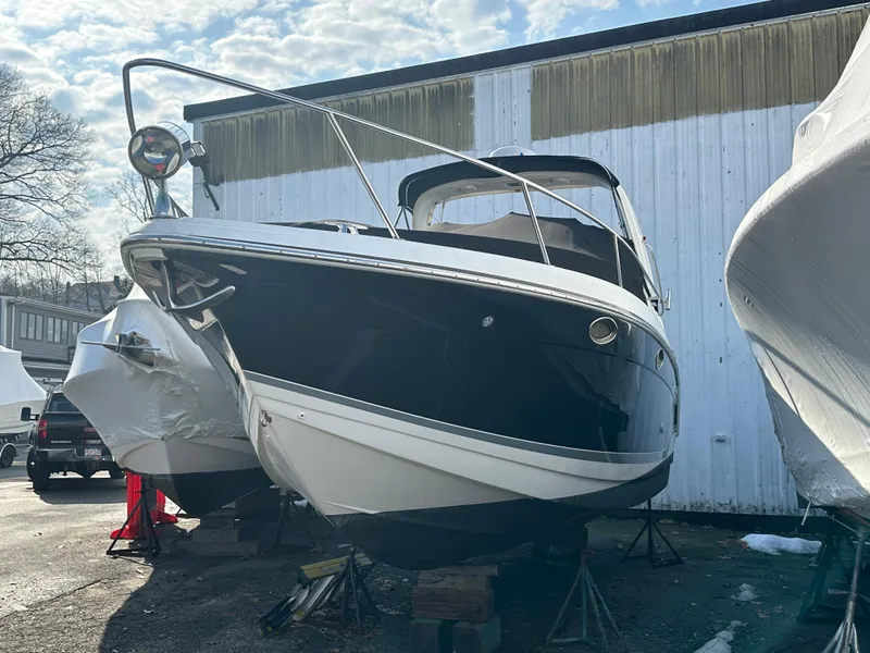 Slide: The Image of 2007 Formula 27 PC boat on stands, black and white hull, outdoor storage. - 2