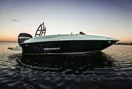 Slide: The Image of 2024 Bayliner E16 Limited Edition boat on calm water at sunset. - 1