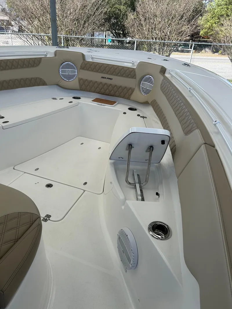 Slide: The Image of 2024 Sea Pro 322 Offshore boat interior with seating and storage compartments. - 10