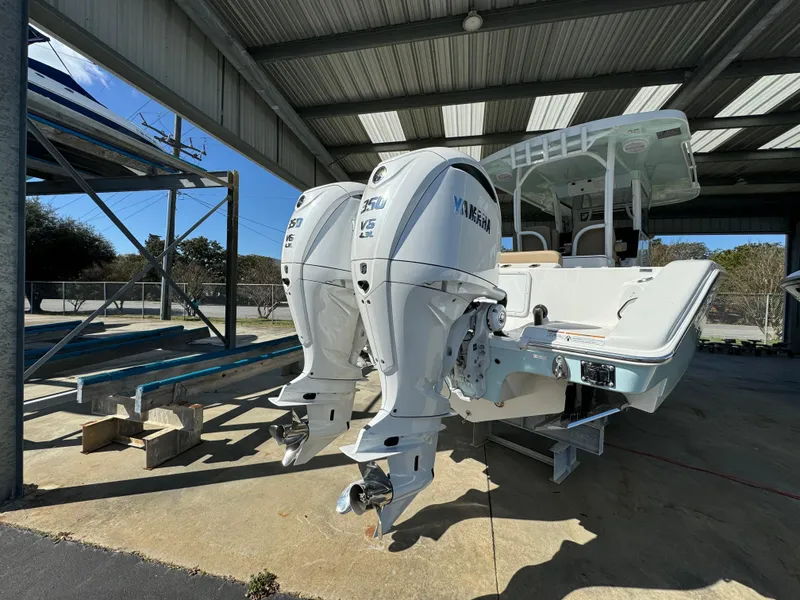 Slide: The Image of 2024 Sea Pro 322 Offshore boat with twin Yamaha engines in a covered dock. - 12