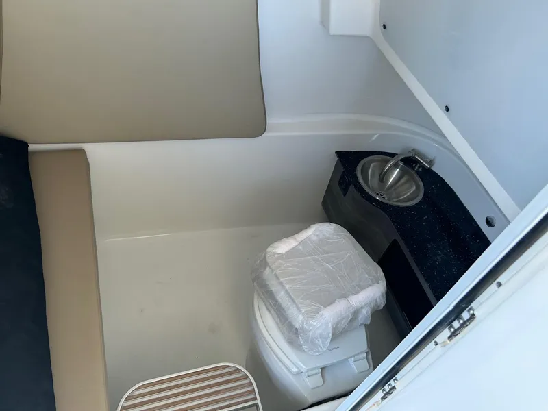 Slide: The Image of 2024 Sea Pro 322 Offshore boat interior with toilet and sink. - 13