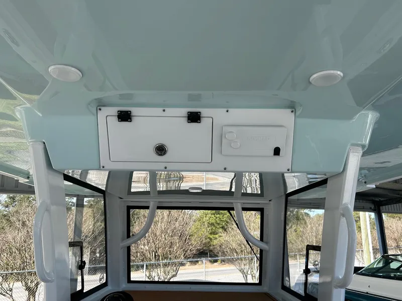 Slide: The Image of 2024 Sea Pro 322 Offshore boat interior with overhead storage compartment. - 14