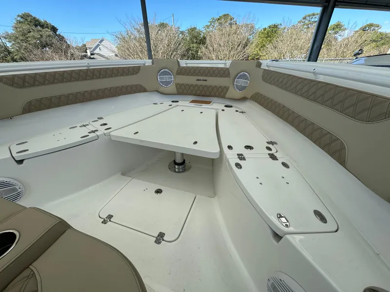 Slide: The Image of 2024 Sea Pro 322 Offshore boat interior with seating and table. - 16