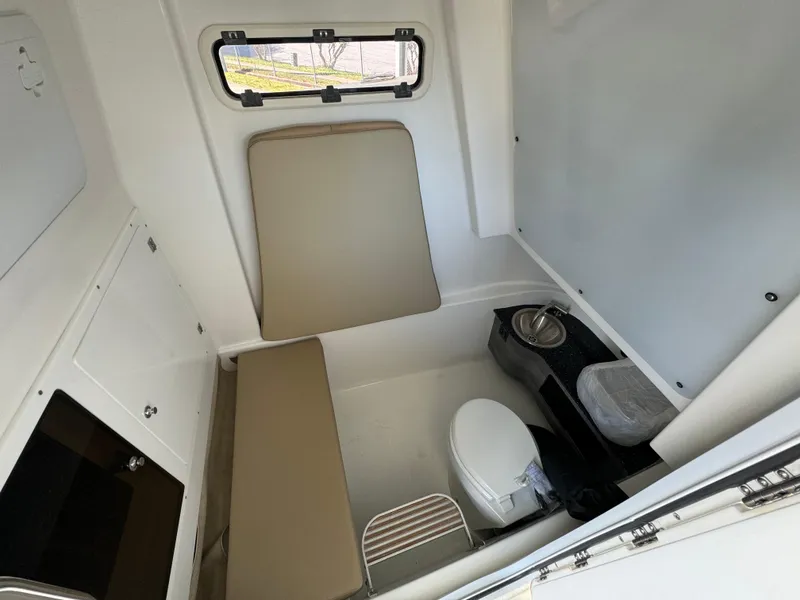 Slide: The Image of 2024 Sea Pro 322 Offshore cabin interior with seating and toilet. - 17