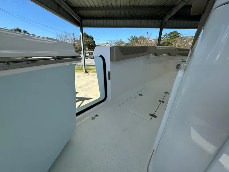 Slide: The Image of 2024 Sea Pro 322 Offshore boat interior under a covered dock. - 18